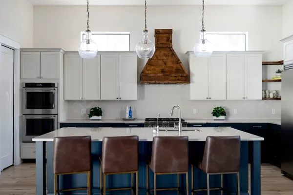 a kitchen with stainless steel appliances granite countertop a sink a stove and a refrigerator