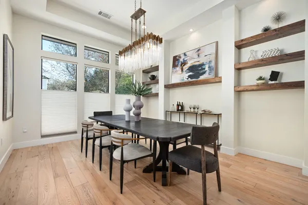 a view of a dining room with furniture and wooden floor