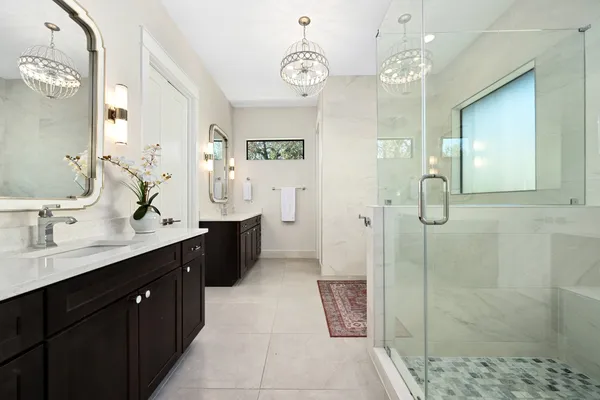 a bathroom with double vanity sink and a mirror