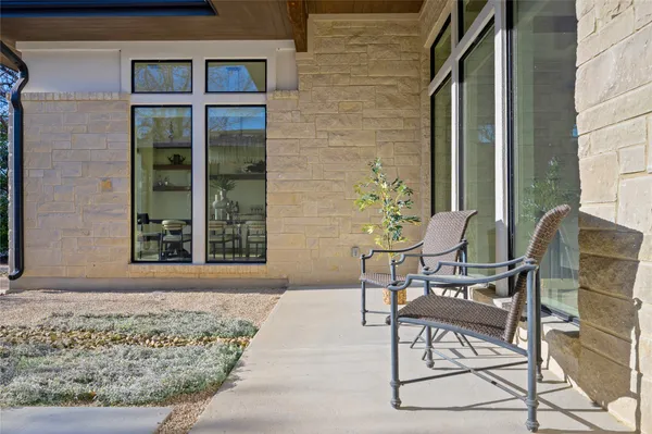 a view of a chairs and table in the backyard