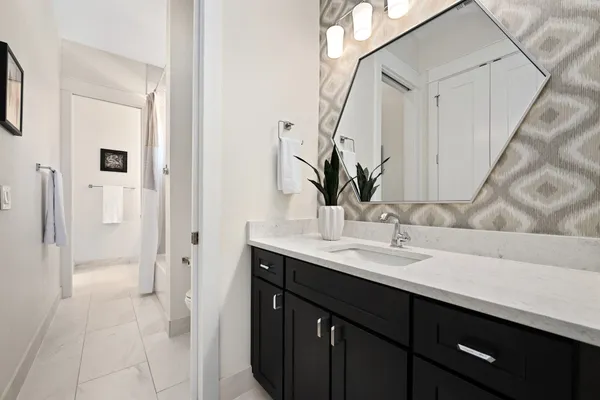a bathroom with a double vanity sink mirror and bathtub
