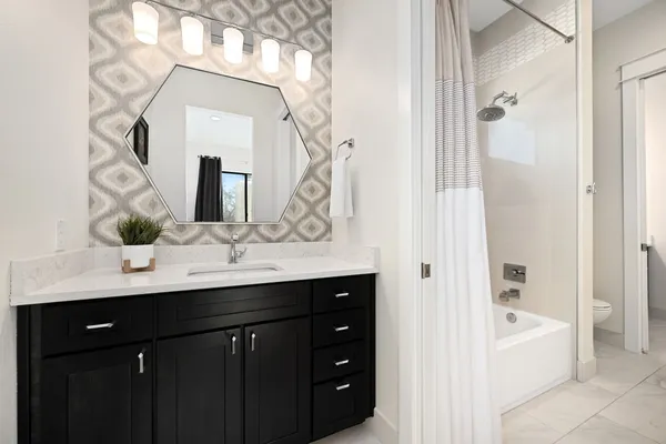 a bedroom with bed and painting on the wall