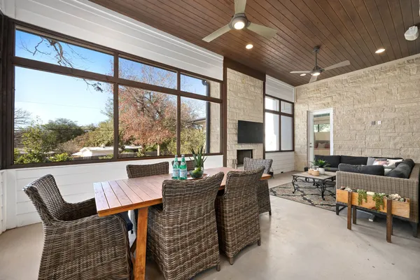 a living room with fireplace furniture and a large window