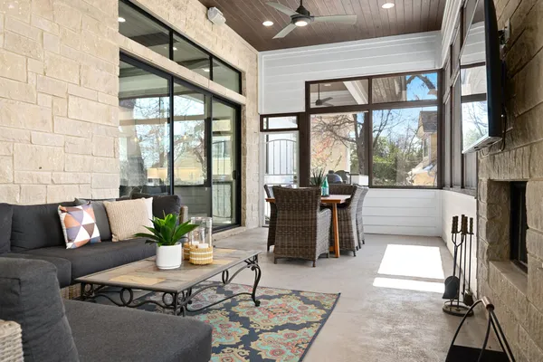 a living room with furniture floor to ceiling window and wooden floor