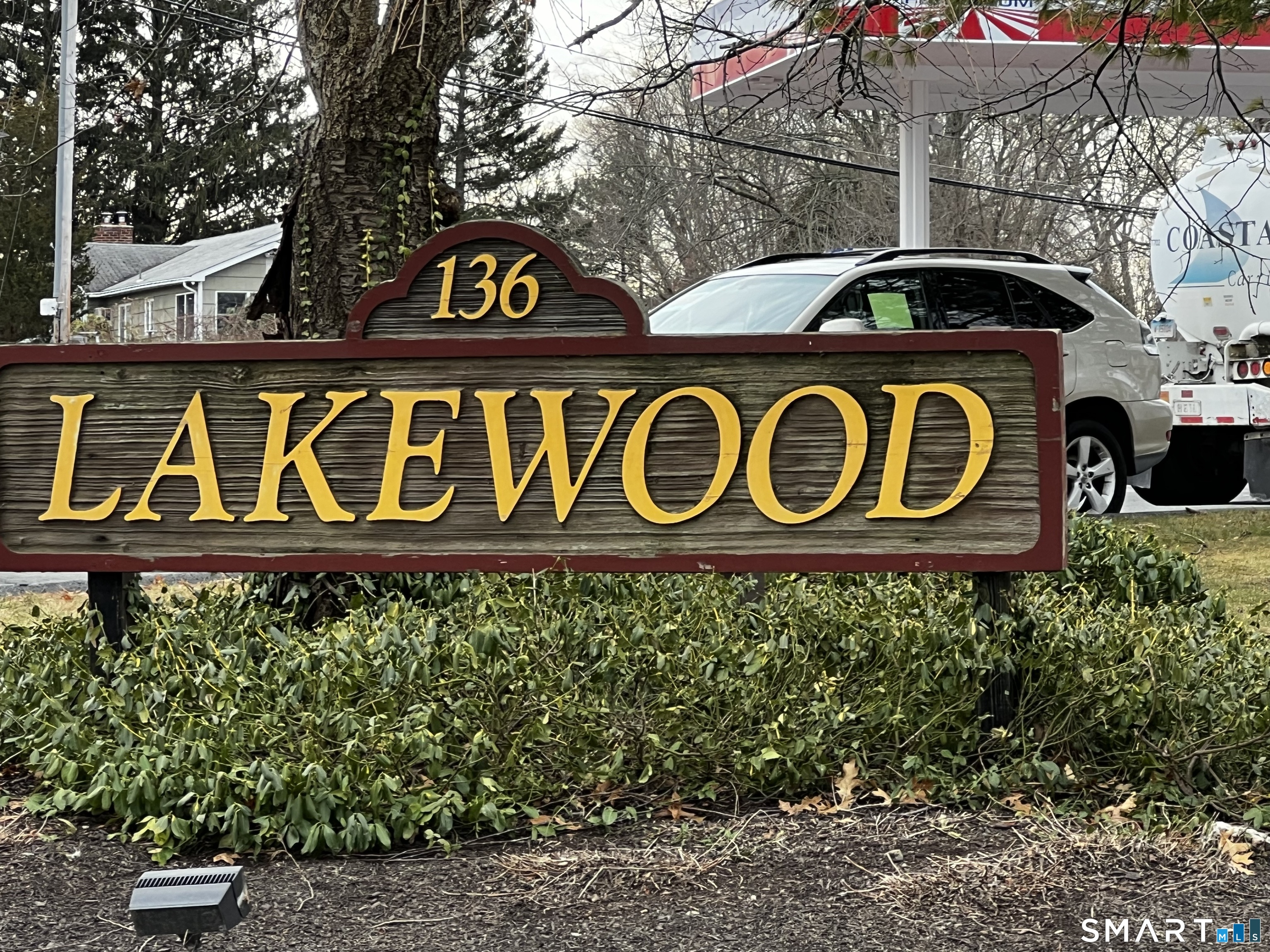 a street sign that is on a wooden wall