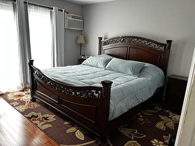 a bedroom with a bed and a dresser