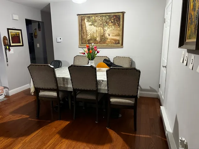 a dining room with furniture and wooden floor