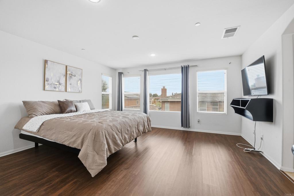 1746 Webber Way Chula Vista, CA 91913 - Photo 14 of 24 a spacious bedroom with a bed and wooden floor