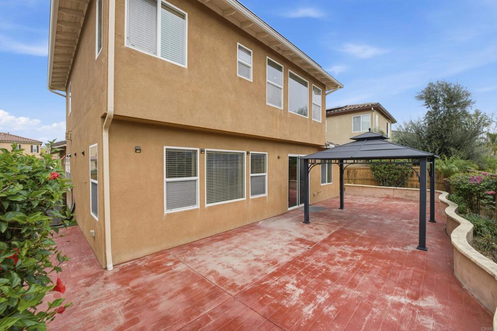 1746 Webber Way Chula Vista, CA 91913 - Photo 17 of 24 a front view of a house with a yard and potted plants