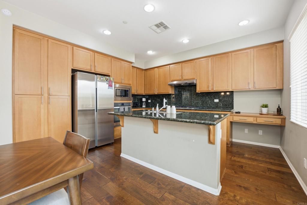 1746 Webber Way Chula Vista, CA 91913 - Photo 6 of 24 a kitchen with stainless steel appliances granite countertop a refrigerator sink and cabinets