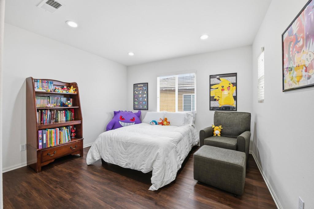 1746 Webber Way Chula Vista, CA 91913 - Photo 9 of 24 a bedroom with a bed wooden floor and book shelf