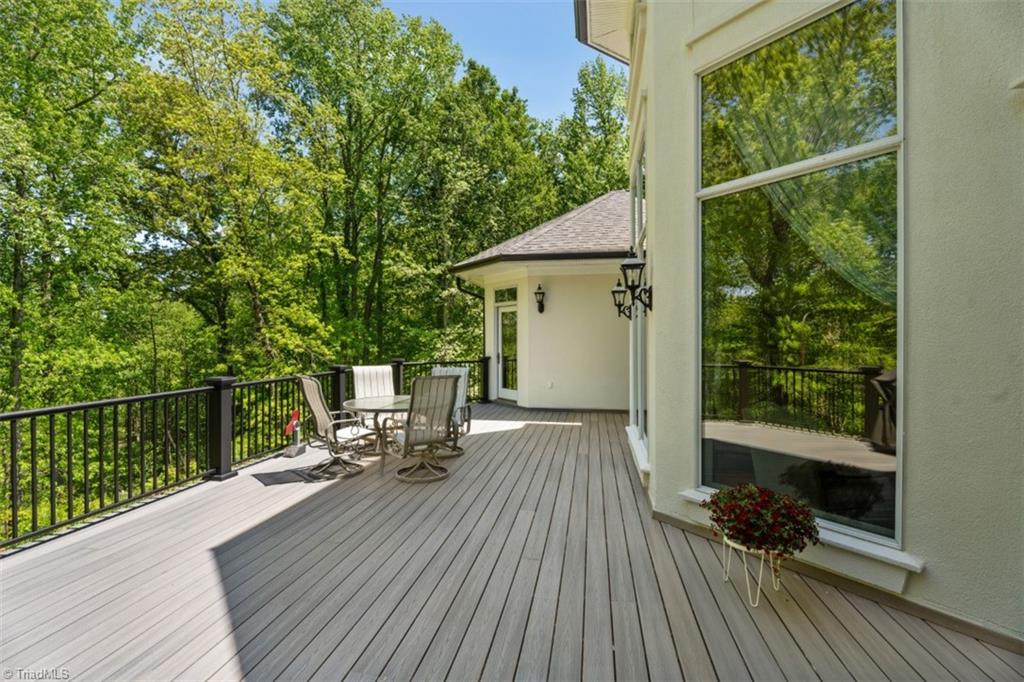 4449 Bent Tree Farm Road Winston-Salem, NC 27106 - Photo 17 of 50 Step out onto the newly re-surfaced synthetic deck to enjoy the wooded view