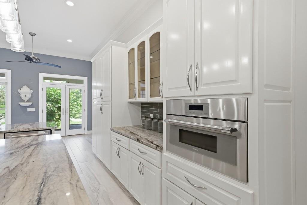 774 Bray Road Southwest Calhoun, GA 30701 - Photo 22 of 106 a kitchen with stainless steel appliances a stove and white cabinets