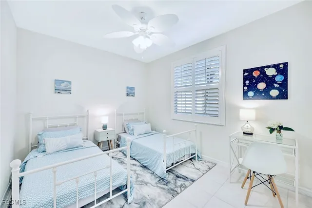 a bedroom with two beds and a table