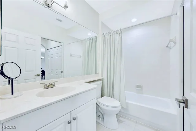 a view of living room with furniture and mirror