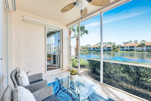 a living room with furniture and a floor to ceiling window