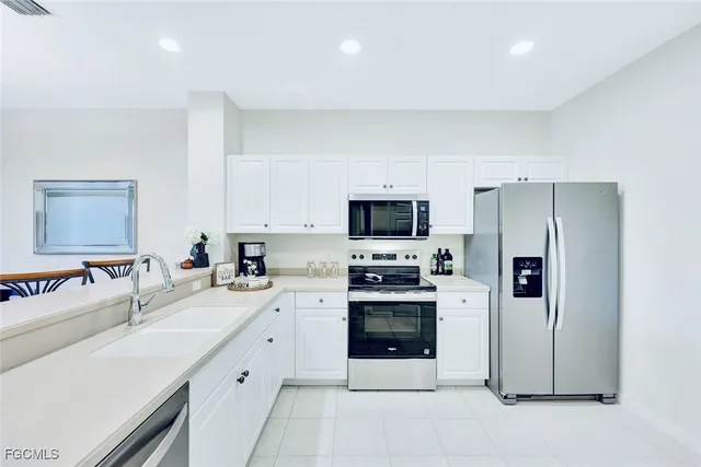 a kitchen with stainless steel appliances a stove sink and refrigerator