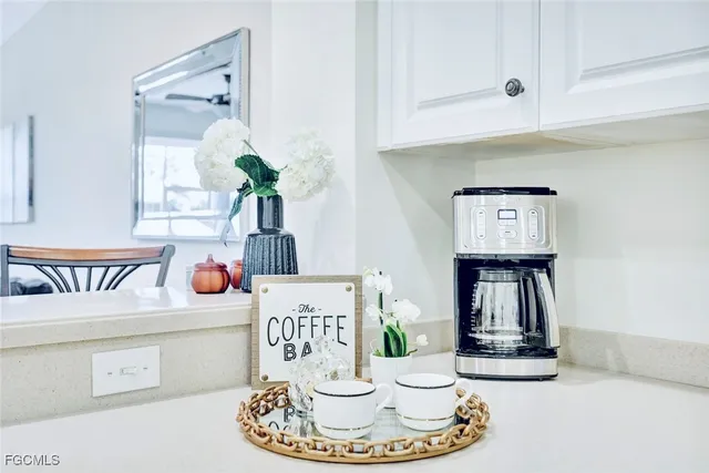 a dining room with table and flowerpot
