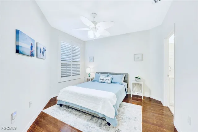 a bedroom with a bed and a ceiling fan