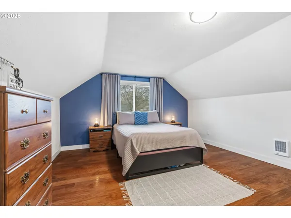 a bedroom with a bed and a dresser