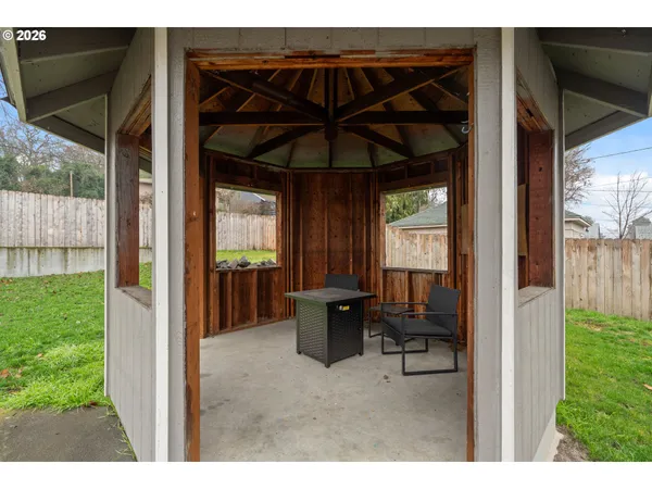 a view of a porch with furniture and a yard