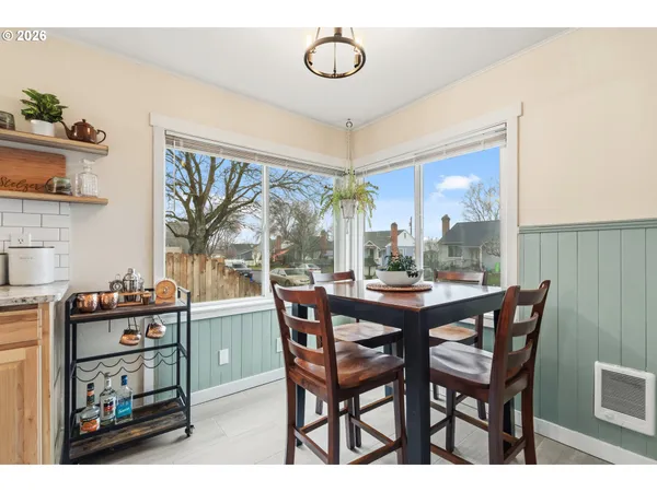 a dining room with a wooden table and chairs