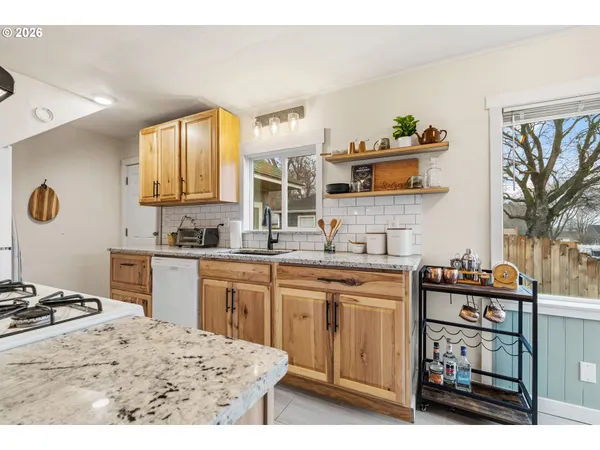 a kitchen with a sink stove and wooden cabinets