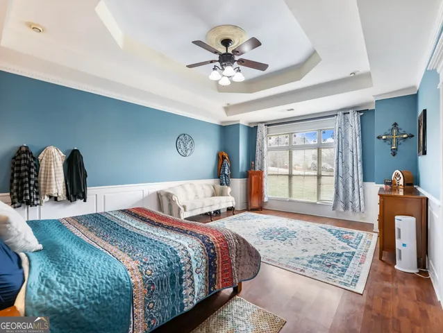 a en suite bathroom with a granite countertop sink and a mirror