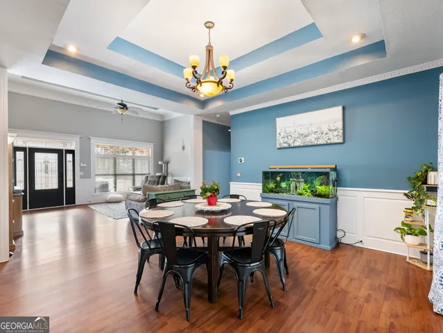 a view of a dining room with furniture and wooden floor
