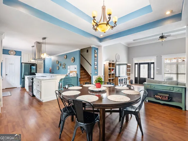 a large kitchen with kitchen island a stove a sink a refrigerator and a stove