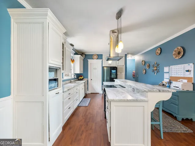 a kitchen with lots of counter top space and dining table