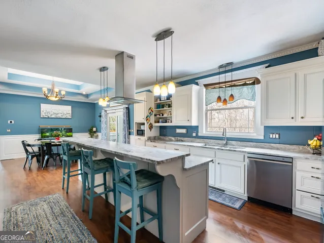 a view of a dining room with furniture wooden floor and chandelier