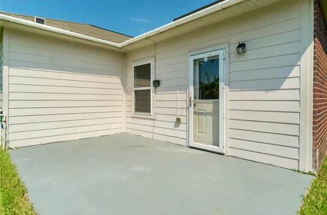 a backyard of a house with table and chairs