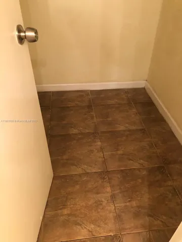 a view of a bathroom with white walls