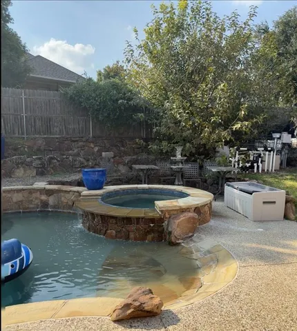 a view of a swimming pool with a patio