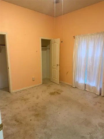 an empty room with closet area