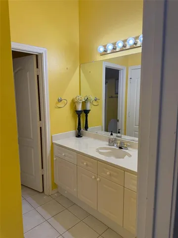 a bathroom with a sink vanity and a mirror
