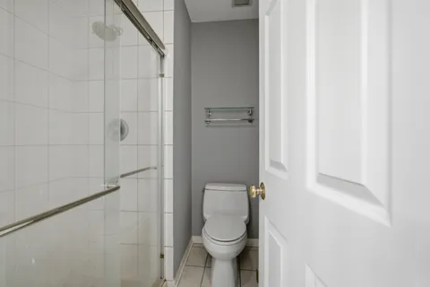 a bathroom with a toilet and a shower