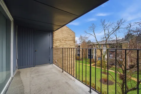 a view of a brick house with a outdoor space
