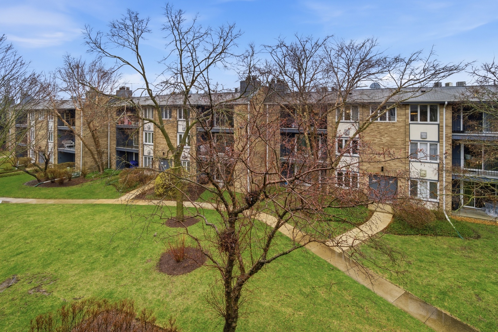 2113 Ammer Ridge Court, Unit 301 Glenview, IL 60025 - Photo 2 of 21 a view of a yard in front of house