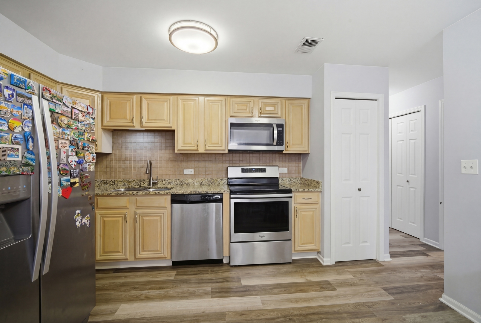 2113 Ammer Ridge Court, Unit 301 Glenview, IL 60025 - Photo 7 of 21 a kitchen with stainless steel appliances granite countertop a stove a sink and a refrigerator