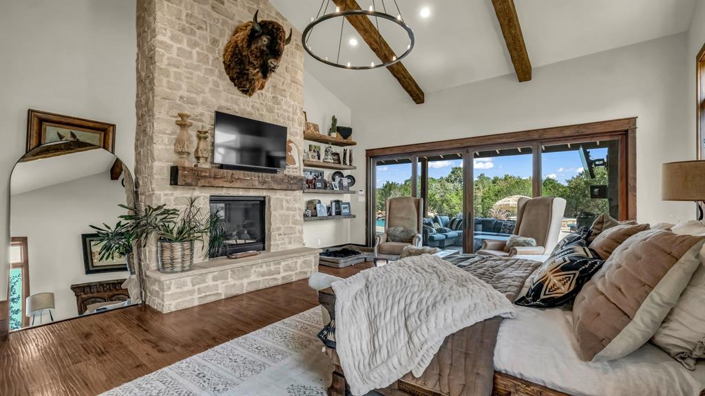 501 Grimes Road Mineral Wells, TX 76067 - Photo 15 of 40 a living room with furniture a flat screen tv and a fireplace