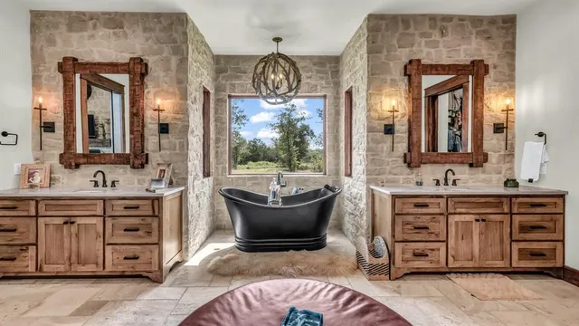 a bathroom with a sink a toilet a mirror and shower