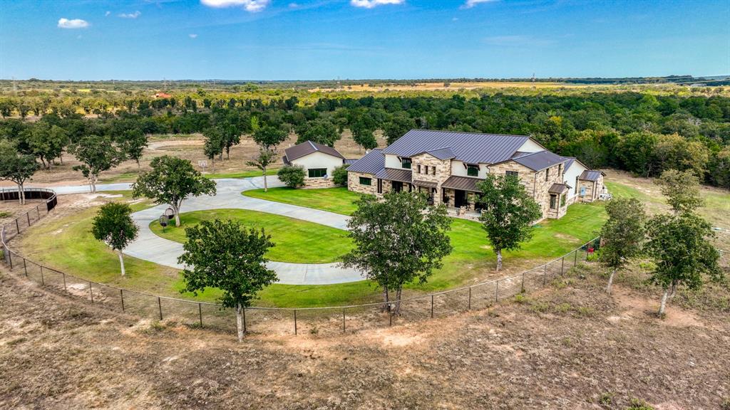 501 Grimes Road Mineral Wells, TX 76067 - Photo 2 of 40 an aerial view of a house with a yard and lake view