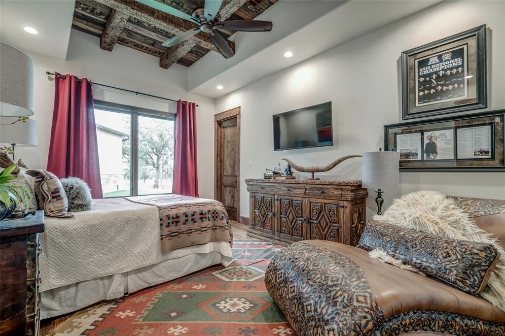 501 Grimes Road Mineral Wells, TX 76067 - Photo 20 of 40 a bedroom with a bed window and flat screen tv
