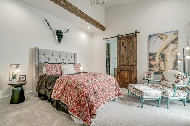 a bedroom with a bed window and flat screen tv