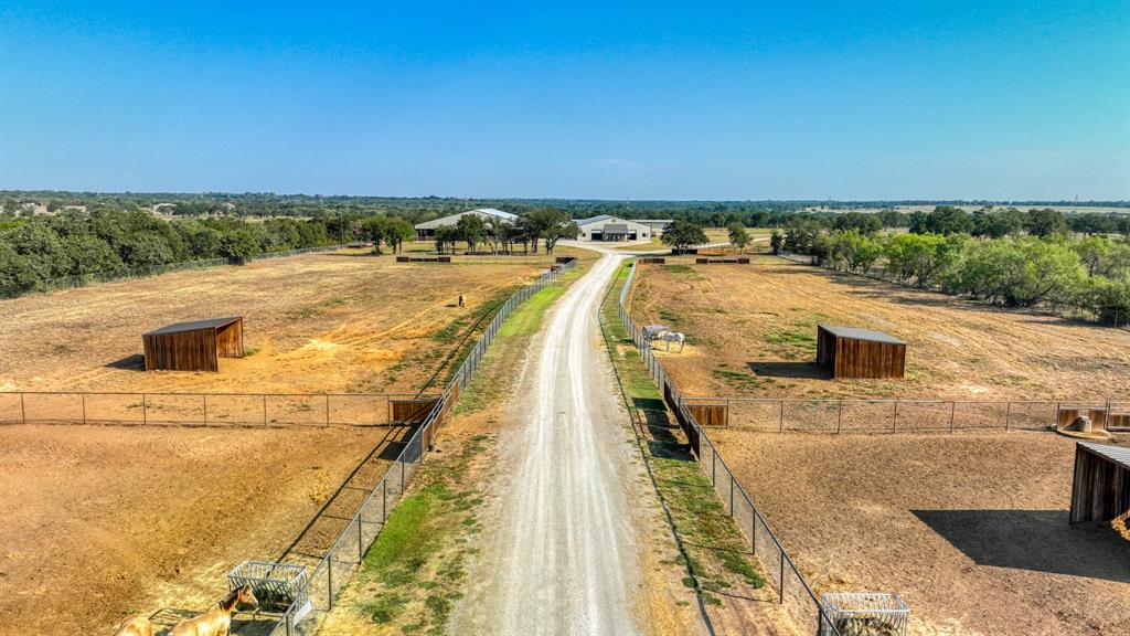 501 Grimes Road Mineral Wells, TX 76067 - Photo 26 of 40 a view of a swimming pool with an outdoor seating and a yard
