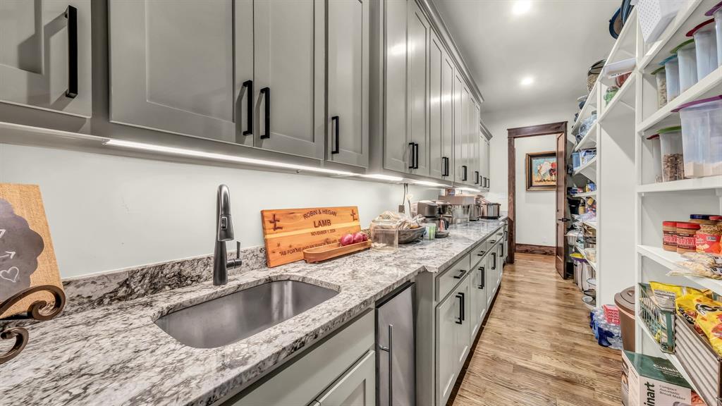 501 Grimes Road Mineral Wells, TX 76067 - Photo 33 of 40 a kitchen with stainless steel appliances granite countertop a sink stove and cabinets