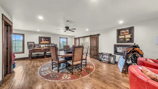 a bedroom with a bed and a dresser next to a window