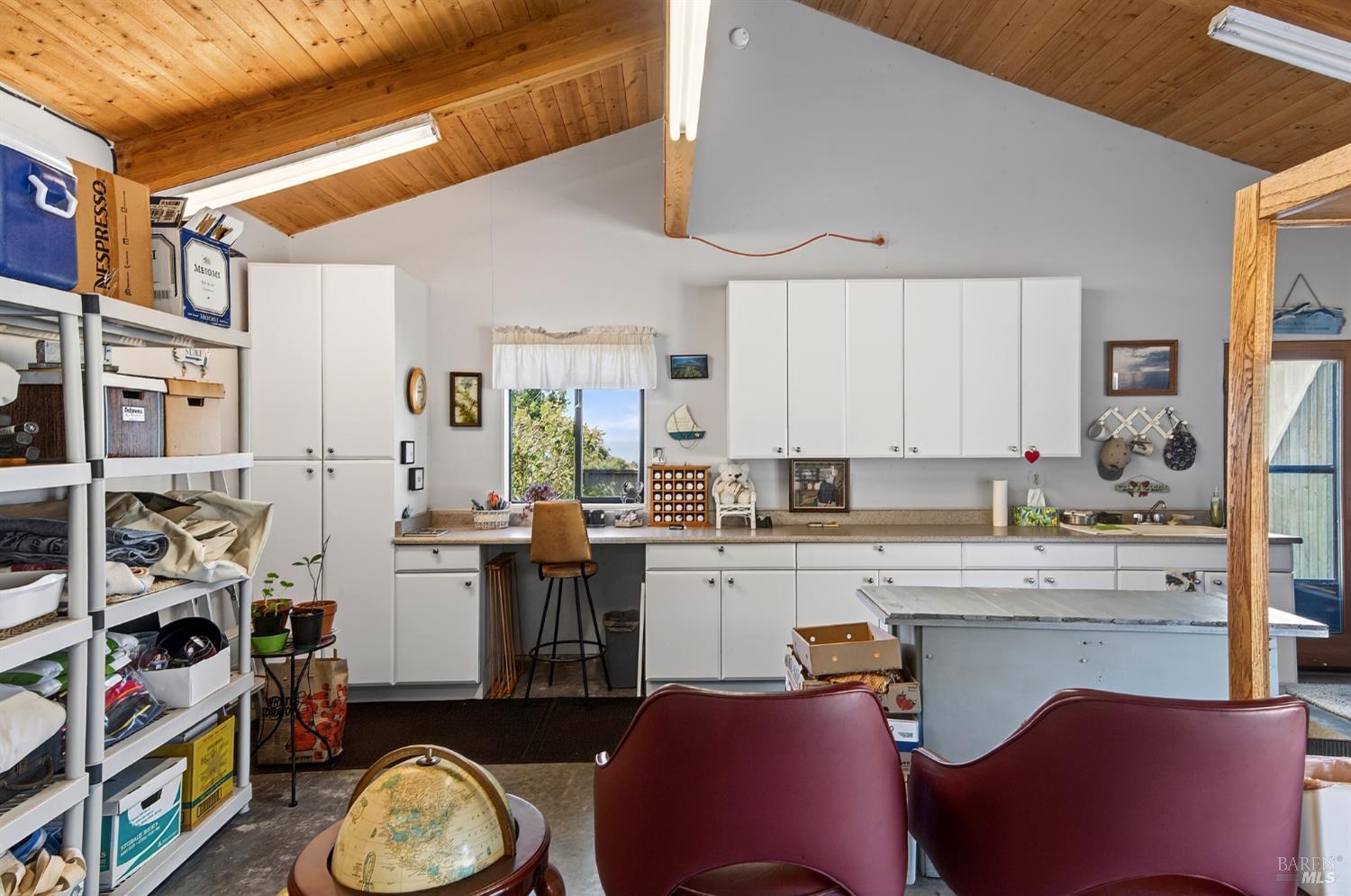 41339 Westwind The Sea Ranch, CA 95497 - Photo 40 of 60 Workshop in garage with counter, sink, shelving and window. Door on right goes to garden patio.